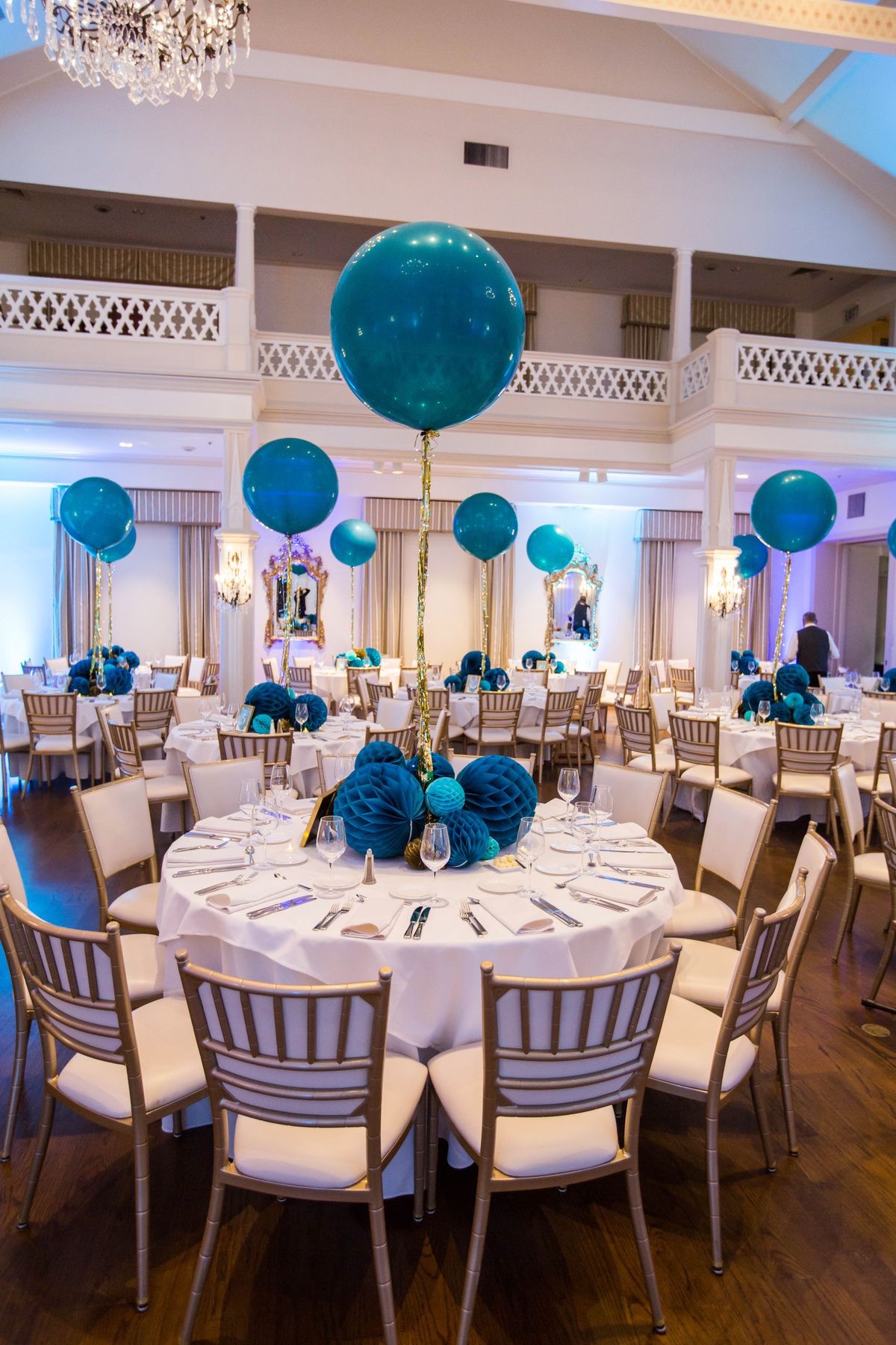 Teal round orb balloon centerpieces on ballroom reception tables